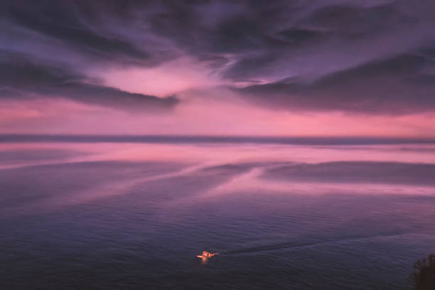 Sea sunset landscape with cloud  sun reflection and ship on the horizon