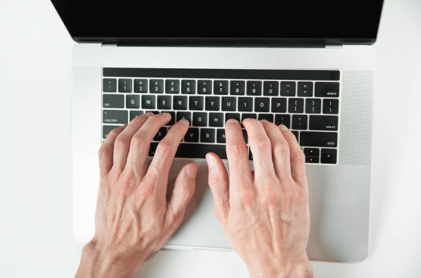 istock top view. man typing on a laptop keyboard 1355886316