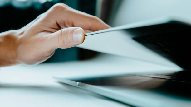 istock close up. man starting work on his laptop 1355886359