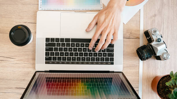 istock top view. designer using a laptop to work with the color palette 1355887524