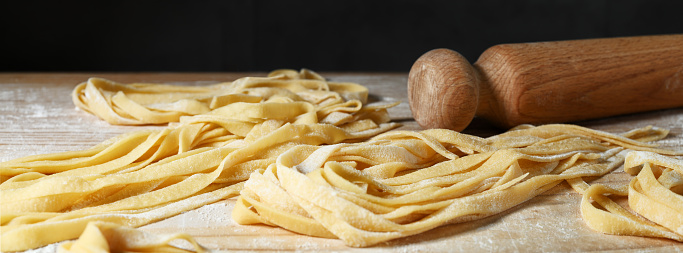 Freshly made tagliatelle, fettucine or tagliolini. Italian food, close-up.