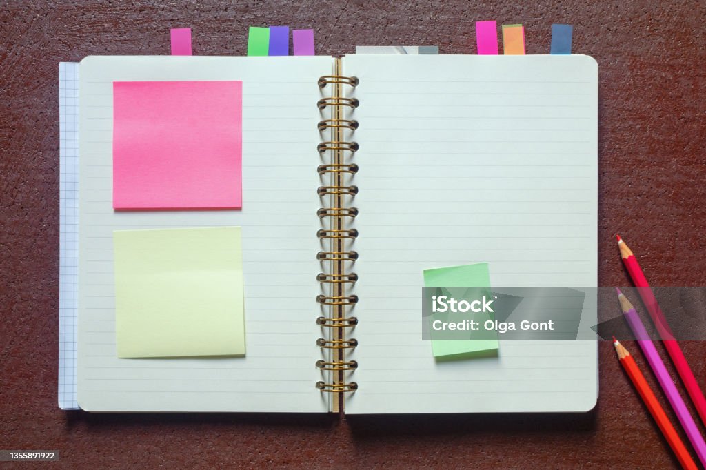 Open spiral bound notebook with blank pages Open spiral bound notebook with  blank pages and post-it notes. Flat lay, copy space Bullet Journal Stock Photo