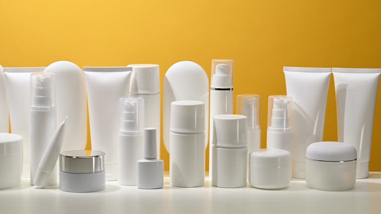 jar, bottle and empty white plastic tubes for cosmetics on a yellow background. Packaging for cream, gel, serum