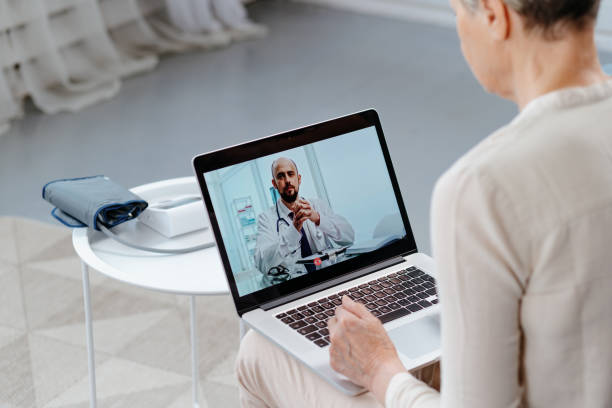 istock doctor talking to the patient via video link 1355895105