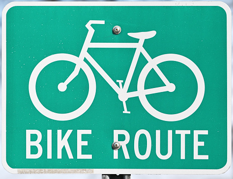 Green and white BIKE ROUTE sign.
