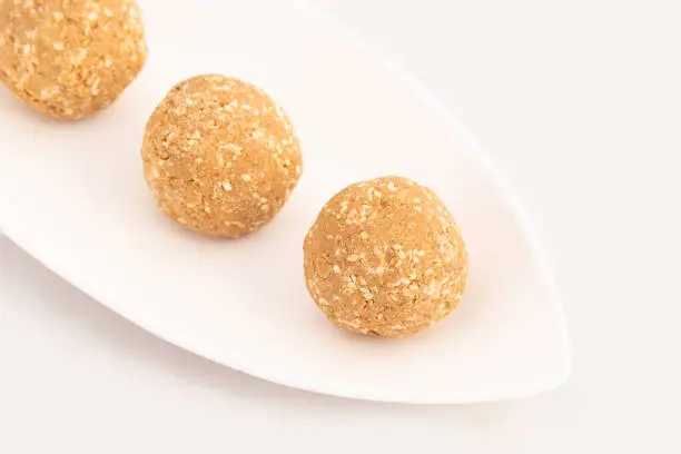 Photo of Indian Mithai Known As Tilgul Ladoo, Gajak Laddu, Gajjak Laddoo, Gazak Or Gachak Is Made Of Sesame Seeds Til, Gur Or Gud Mixed With Roasted Mugfali, Kaju, Badam, Pista, Moongfali And Honey Shahad