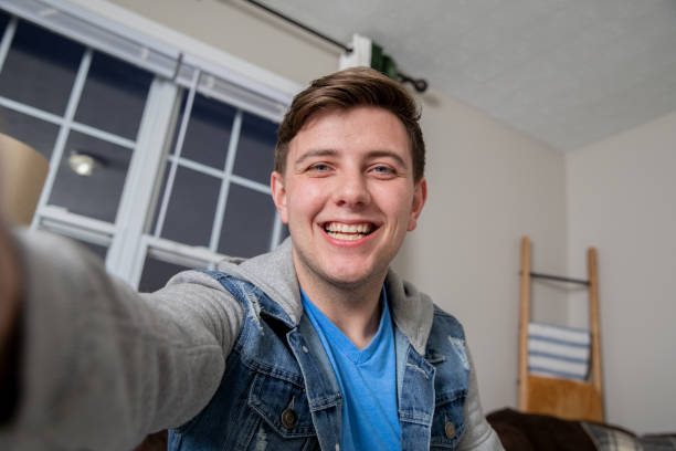 istock Young Man taking a selfie with smart phone 1355900942