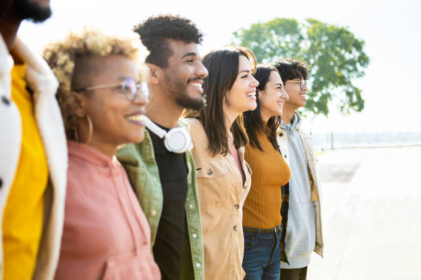 istock Side view of united multiracial people hugging each other in cooperation 1355902582