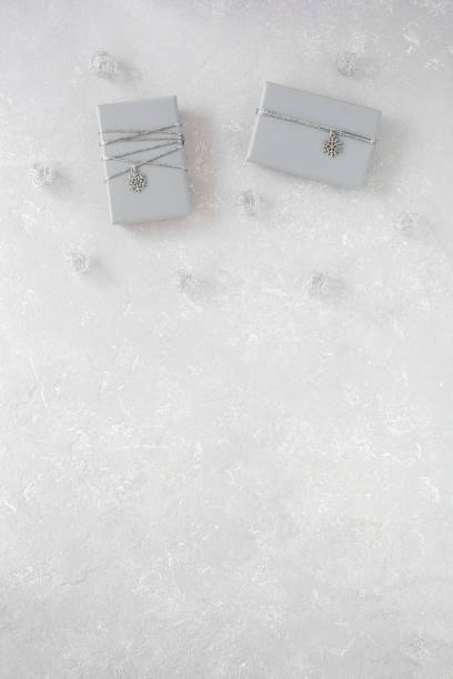 istock Grey Christmas gift boxes decorated with snowflakes on grey, copy space 1355902746
