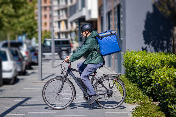 istock deliveryman riding electric bicycle in city 1355903745