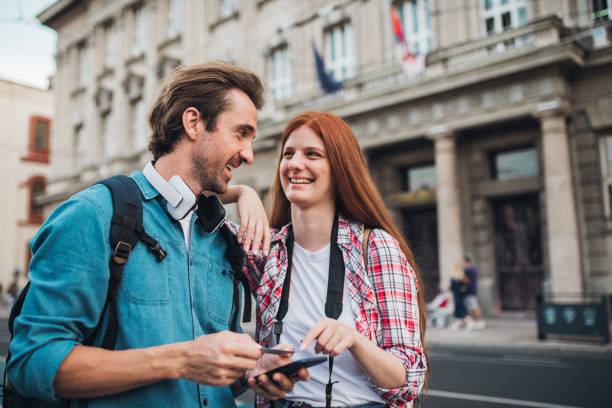 istock Happy couple on vacation banking online 1355904733