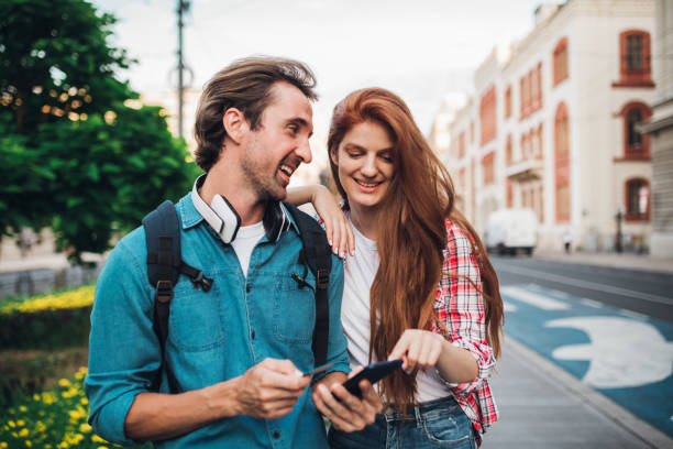 istock Happy couple on vacation banking online 1355904743