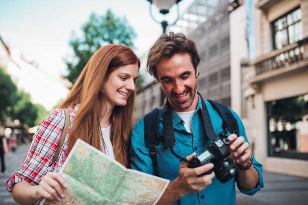 istock Happy couple on vacation exploring the city and having fun 1355904763