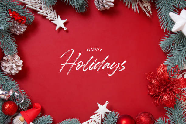 istock Happy Holydays text and frame made of Christmas decorations on a red background vertical format 1355904842