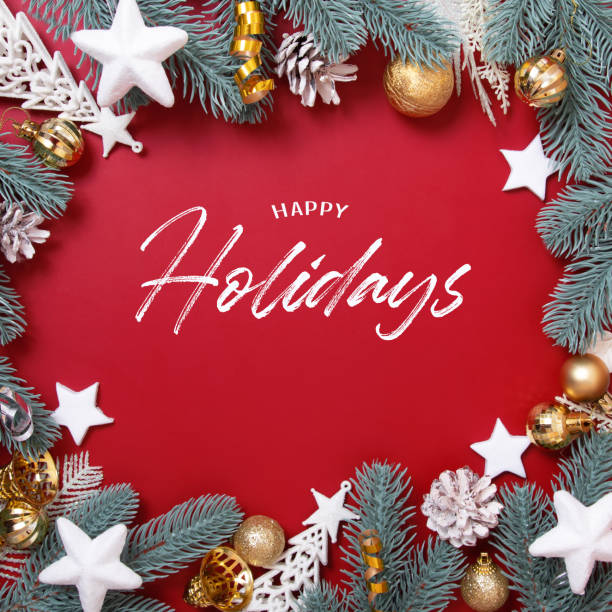 istock Frame made of Christmas decorations and Happy Holidays text on a red background 1355904868