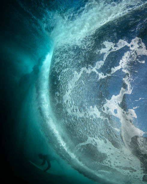 istock Underwater view of a surfer through a large wave 1355904915