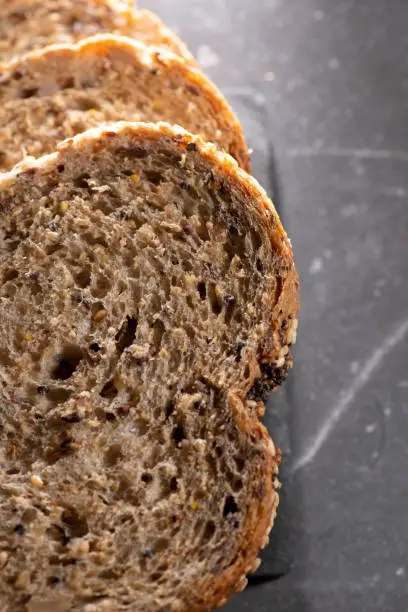 Detailed close up of high fibre low GI seven seeds and grain bread in low key lighting