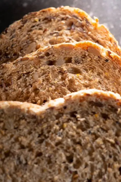 Detailed close up of high fibre low GI seven seeds and grain bread in low key lighting