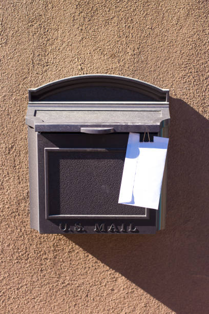 istock Sunlit Mailbox with Letter Waiting for Mail Carrier 1355918766