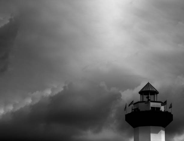 top of lighthouse with cloudy sky behind