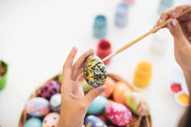 Asian girl in easter egg festival. Asian young pretty woman enjoy painting a water colors on fantasy eggs for Easter egg festival. Beautiful colorful fancy Easter egg in bucket. The symbolic of Easter egg festival concept. easter egg coloring stock pictures, royalty-free photos & images