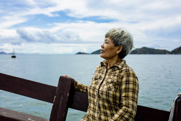 istock asian  senior adult enjoy vacation using ship 1355925301