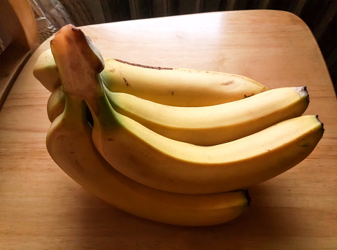 Fresh ripe banana fruit on kitchen tabletop .