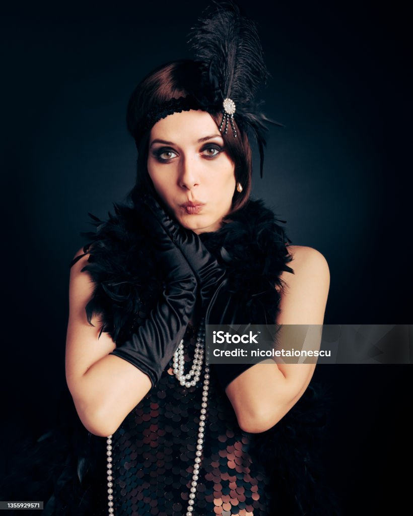 Funny Surprised Flapper Girl Wearing Feathers and Pearls accessories Fashionable retro woman feeling excited and surprised ready to party Flapper Style Stock Photo