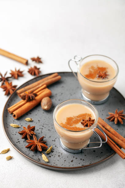 Masala tea in a glass cup with cardamom, star anise and cinnamon. Antiviral drink for immunity. Masala tea in a glass cup with cardamom, star anise and cinnamon. Antiviral drink for immunity. Cardamom stock pictures, royalty-free photos & images