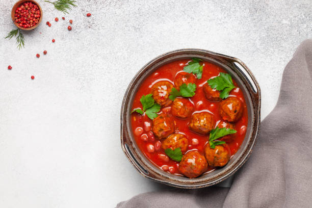 istock Meat or vegetable meatballs in tomato sauce with beans. Top view. 1355940231