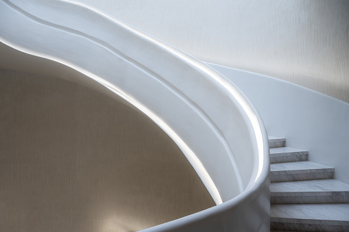 A top view of a modern white spiral staircase