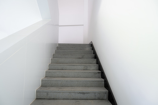 Wooden staircase to second floor of the house next to entrance hall and corridor.