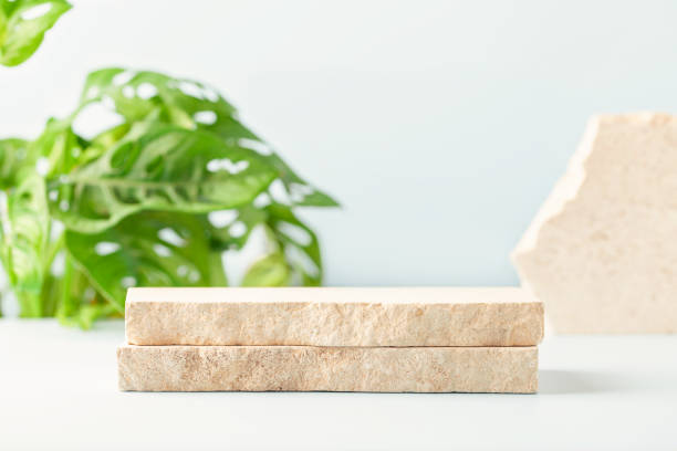 Composition of travertine blocks on blue background. Abstract modern background. Natural materials.