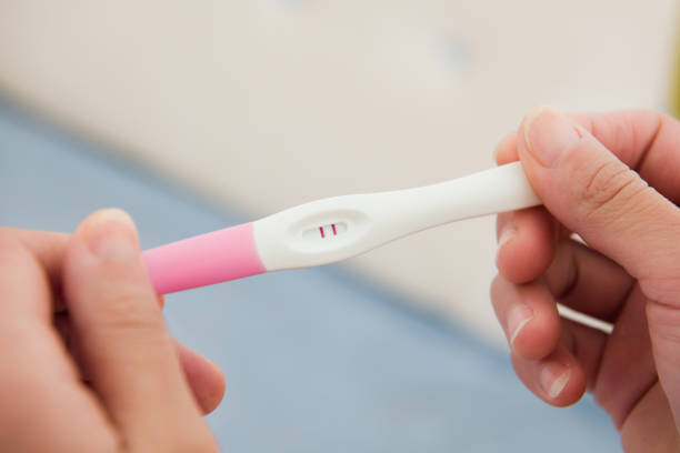 istock pregnancy test kit in female hand on blurred background. 1355941439