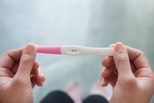 istock pregnancy test kit in female hand on blurred background. 1355941449