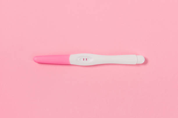 istock Realistic Positive Pregnancy Test. Isolated on pink background. 1355941995