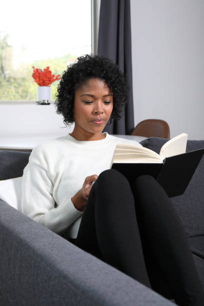 istock Analog Book Reader African American Woman MS Vertical 1355942084