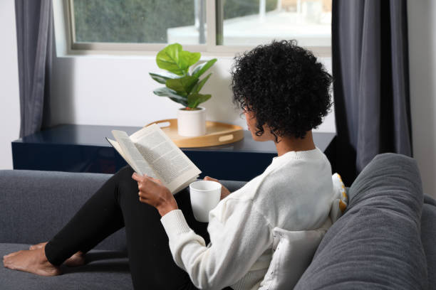 istock Analog Book Reader African American Woman Over the Shoulder 1355942140