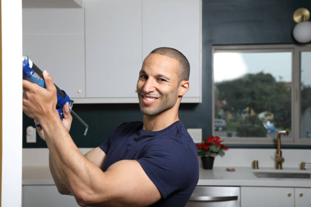 istock Caulking Gun Turkish Man Smiles at Camera Horizontal 1355942182
