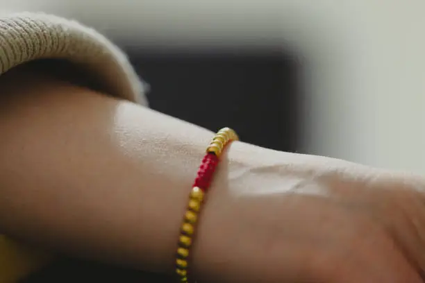 Gold bracelet on woman wrist