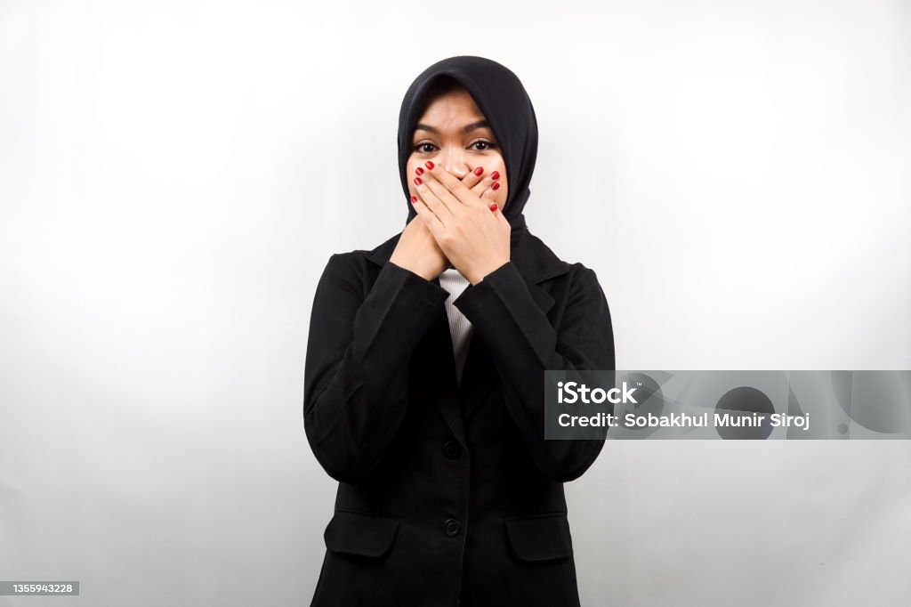 Beautiful young asian muslim business woman shocked, surprised, disbelieving, getting shocking information, with hands covering mouth isolated on white background 20-24 Years Stock Photo
