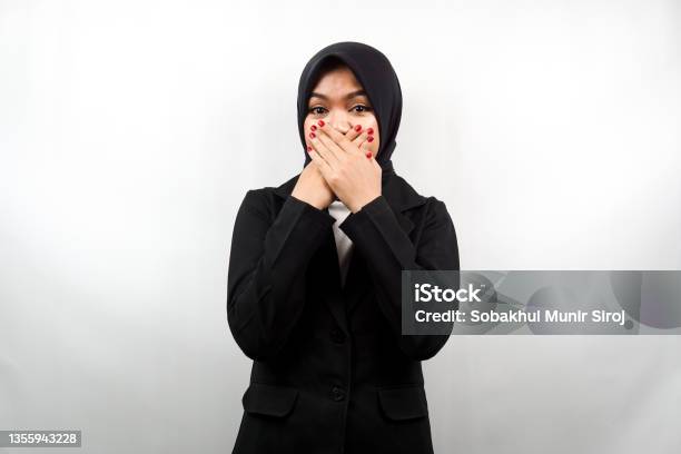 Beautiful Young Asian Muslim Business Woman Shocked Surprised Disbelieving Getting Shocking Information With Hands Covering Mouth Isolated On White Background Stock Photo - Download Image Now