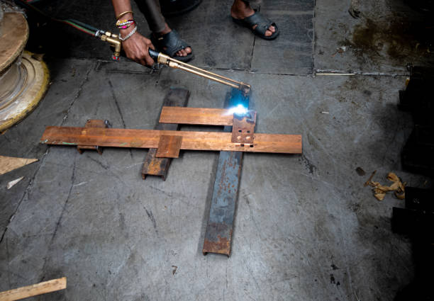 A man joining the copper sheets with the help of gas welding process. A man joining the copper sheets with the help of gas welding process. oxyacetylene stock pictures, royalty-free photos & images