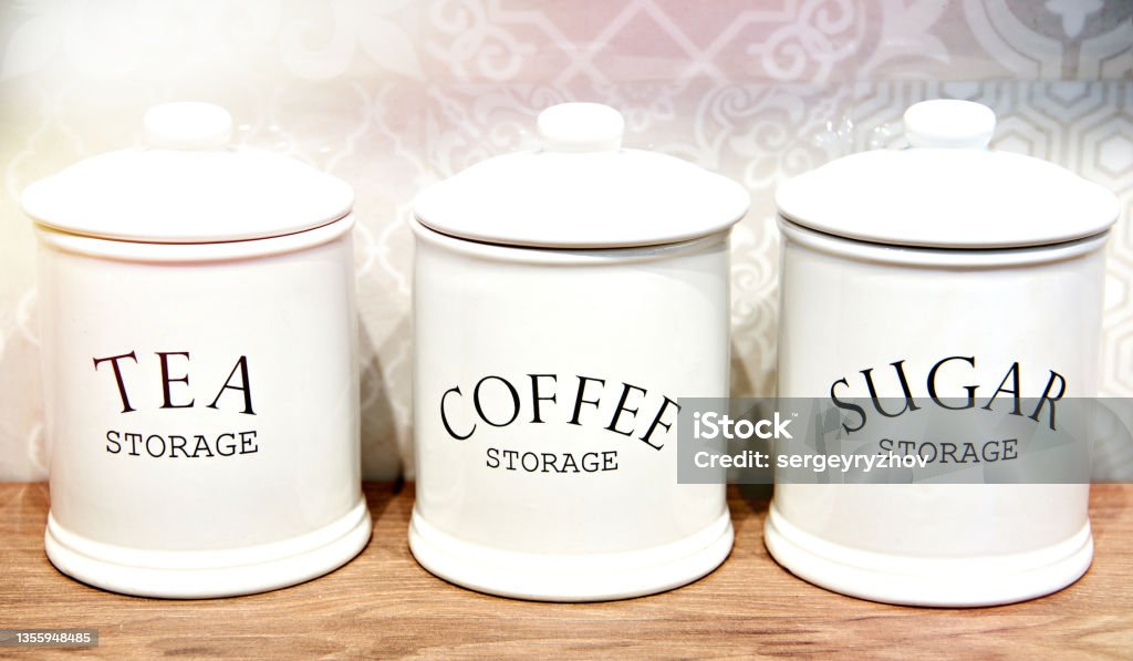 Porcelain white jars for tea, sugar and coffee Porcelain white jars for tea, sugar and coffee on kitchen Canister Stock Photo
