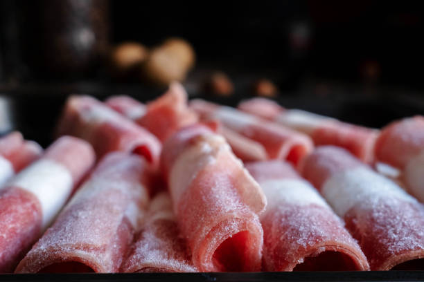 Frozen Mutton Rolls Frozen Mutton Rolls in cooking pan, ready for cooking mutton roll for chinese hot pot stock pictures, royalty-free photos & images
