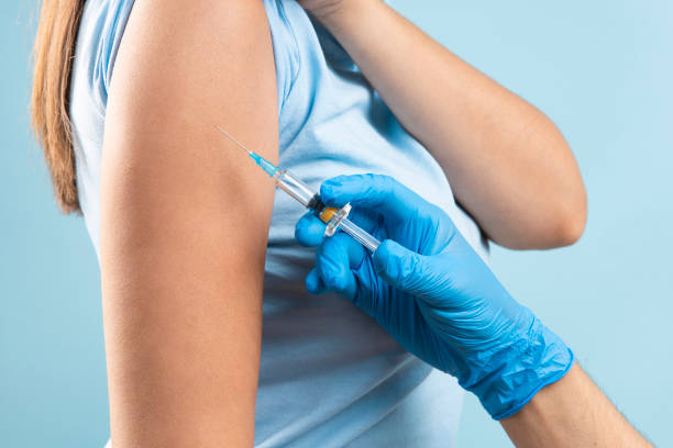 istock Doctor applying a vaccine on a woman's arm 1355951982