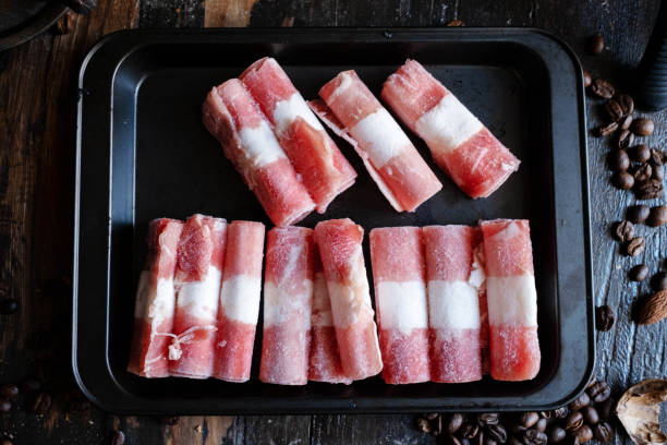 Frozen Mutton Rolls Frozen Mutton Rolls in cooking pan, ready for cooking mutton roll for chinese hot pot stock pictures, royalty-free photos & images