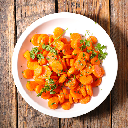 fried carrot with parsley in plate