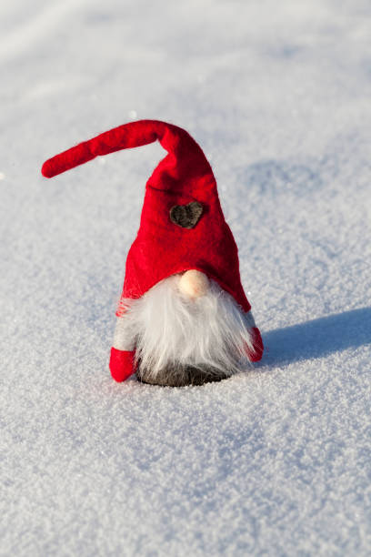 istock a dwarf with a red hat in the snow 1355957716