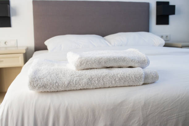istock White clean towels stacked on the hotel bed 1355961022